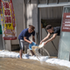 These men are trying to empty water from the property.